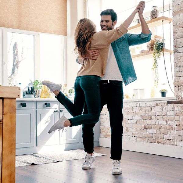 young couple dancing in kitchen