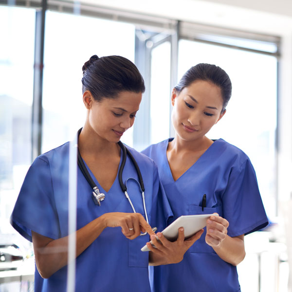 two nurses looking at tablet