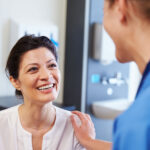 woman smiling talking to nurse