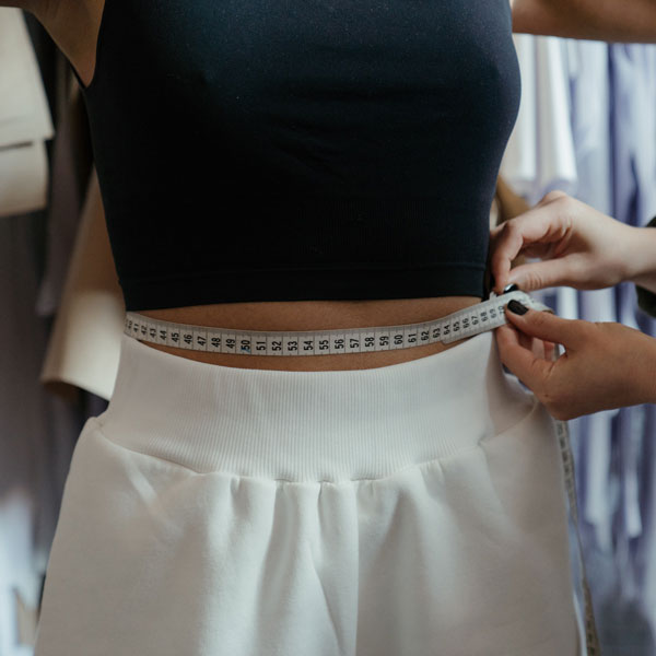 woman having her waist measured